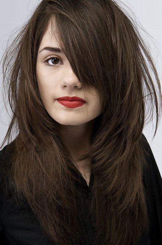 Fille avec une cascade de coupe de cheveux et une frange oblique