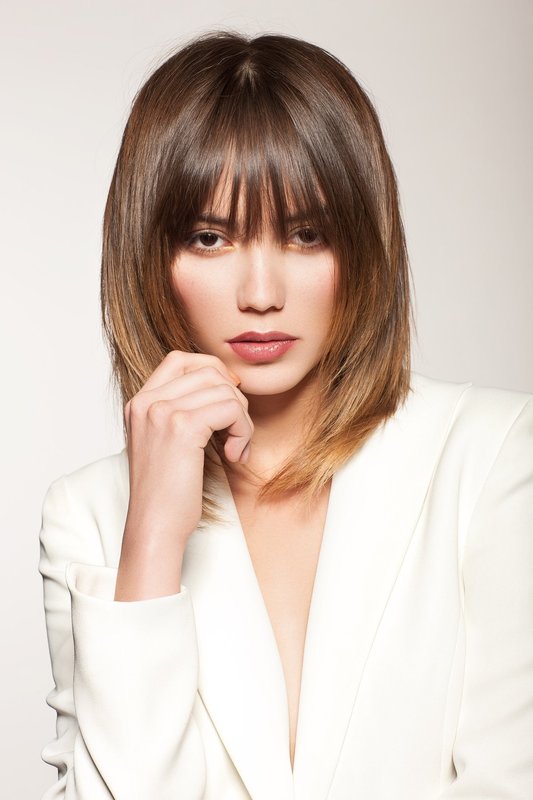 Fille avec une échelle de coupe de cheveux et une frange droite