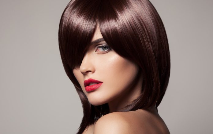 Fille avec une coupe de cheveux à la mode sur cheveux moyens